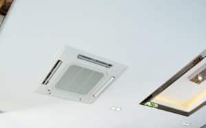 white Ceiling mounted cassette type air conditioner in house.