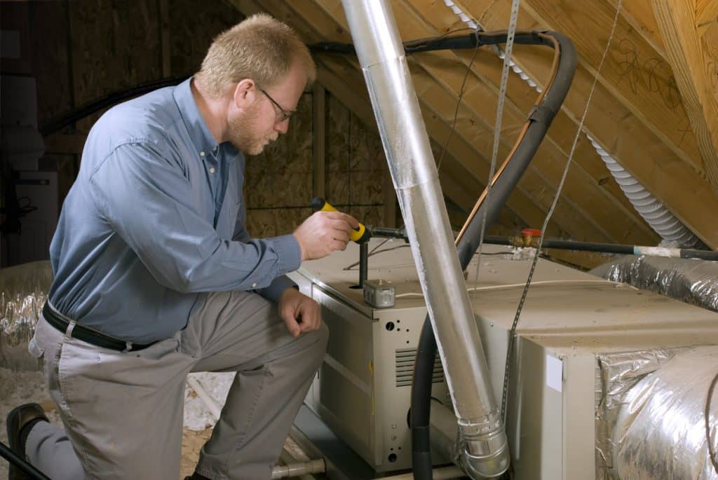 Service Man Inspects Furnace