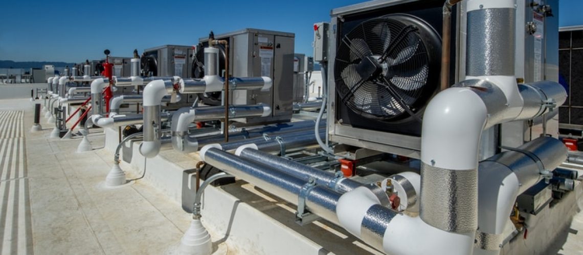 Fans and ducting for ventilation in a rooftop HVAC system.Rooftop heat pump hot water heaters.